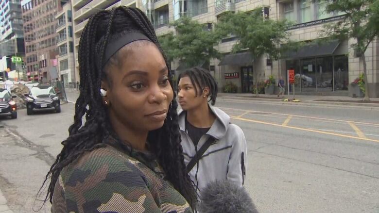 A woman stands outside Eglinton Station.