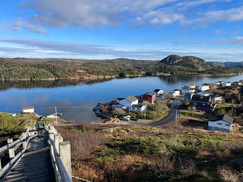 A panoramic photo of an outport ocmmunity. There are Fjords in the background.