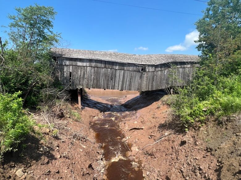 A side profile of the covered bridge shows a dangerous sag in the bridge