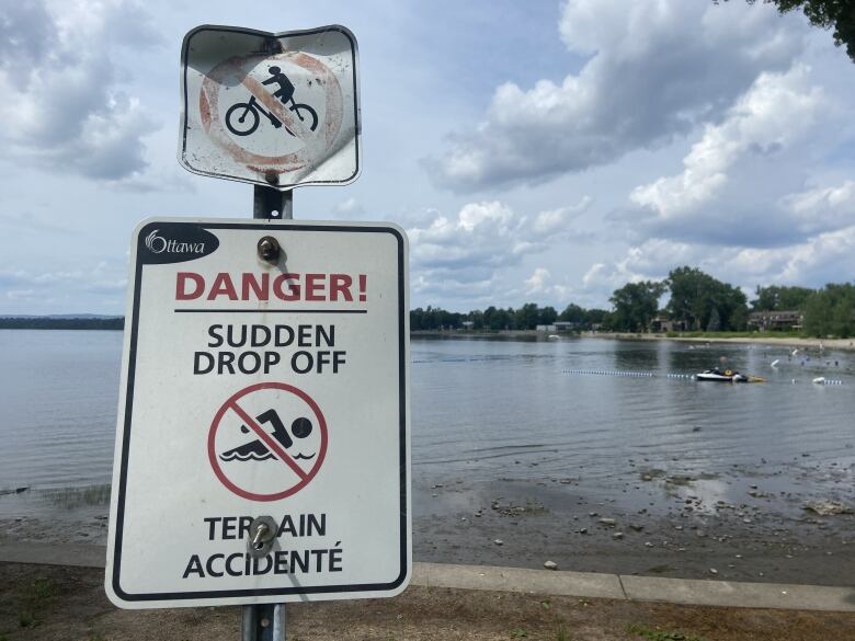 Sign posted at beach warning of a drop off.