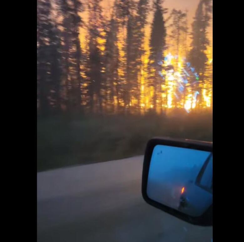 Flames on the side of the road from a moving pickup