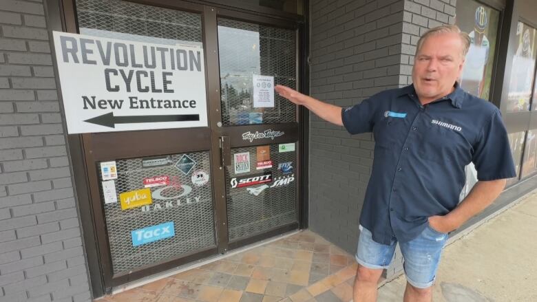 A man standing outside a shop