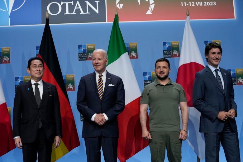 Japan's Prime Minister Fumio Kishida, President Joe Biden, Ukraine's President Volodymyr Zelenskyy, and Canada's Prime Minister Justin Trudeau, stand together.