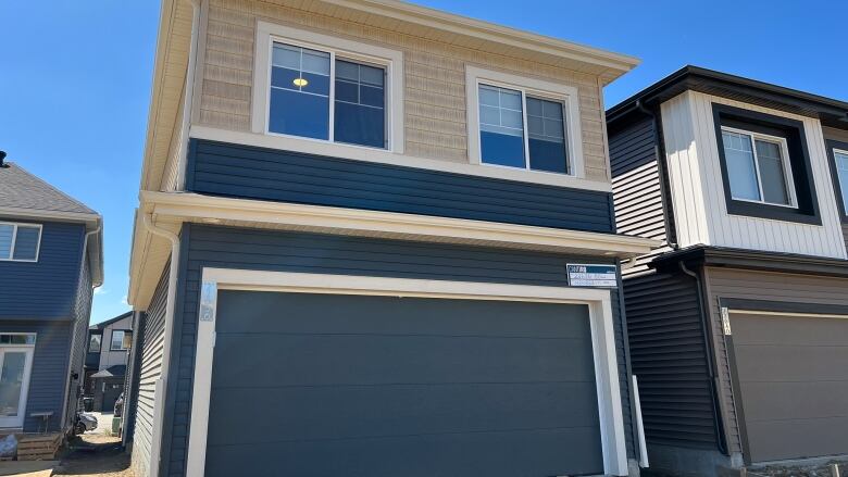 Blue garage with brown garden suite.