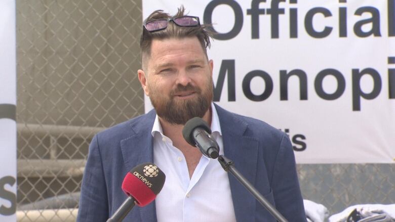 Man in suit in front of podium.