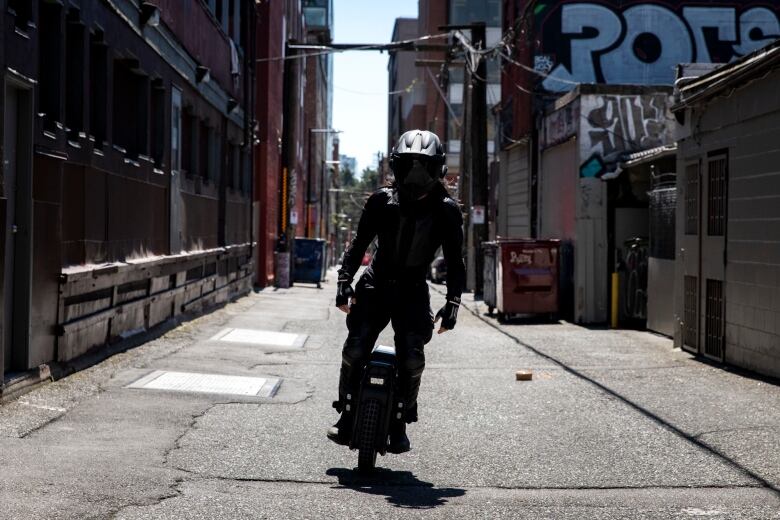 Gabriel Kwok rides his electric unicycle in Vancouver's Chinatown.