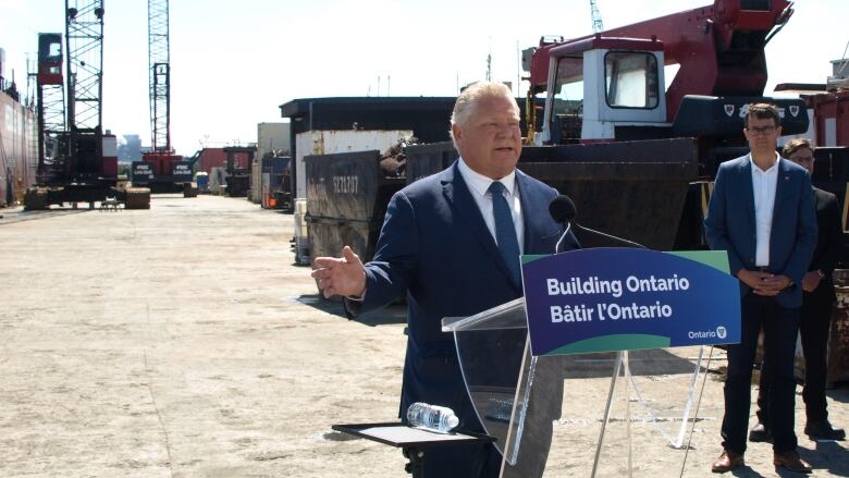 Doug Ford stands behind a podium that says 