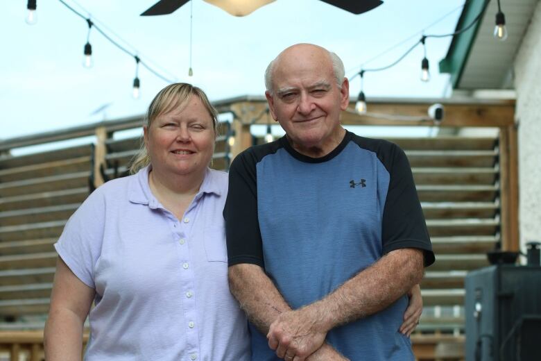 A woman who is blind and a man pose for a photo. 