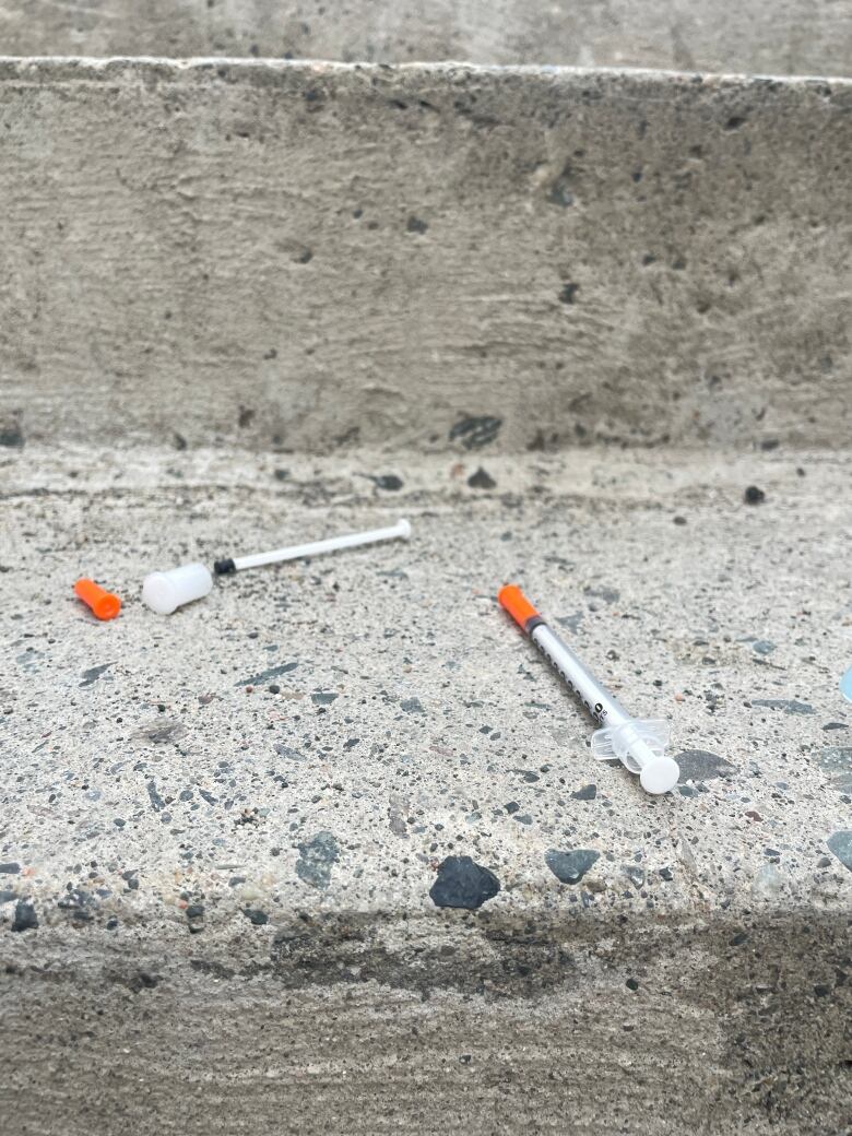 discarded injection needles on a staircase