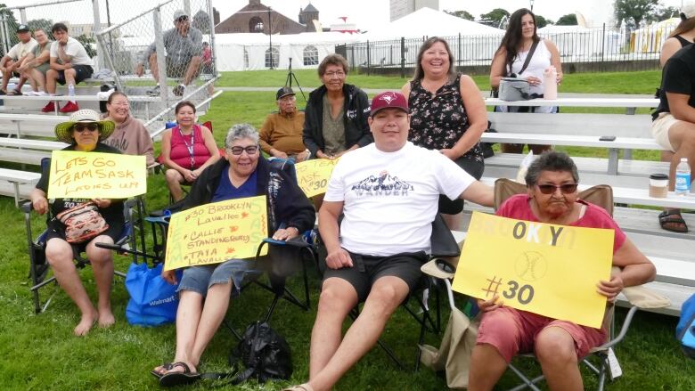 A group of grandmothers holds signs supporting their grandchildren at a sporting event in Halifax Nova Scotia.