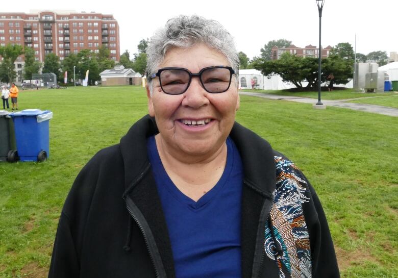 A Cree grandmother stands in a sports field in Halifax Nova Scotia.