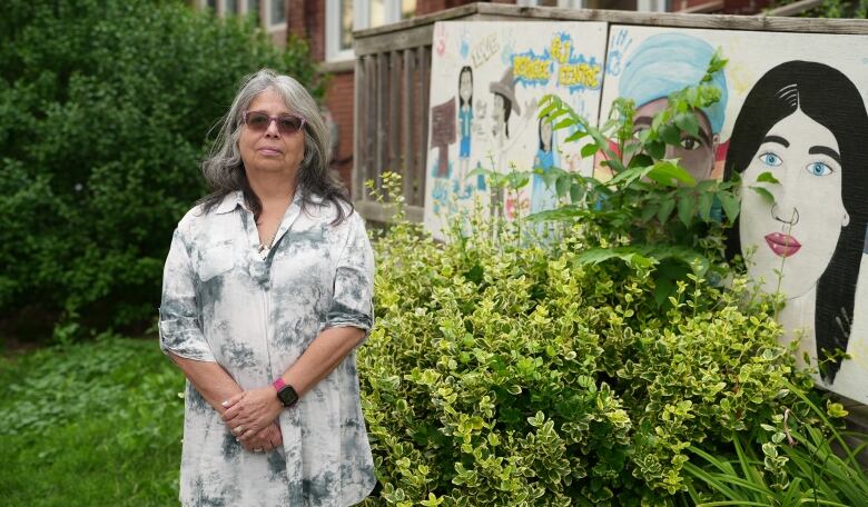 Loly Rico stands outside the FCJ Refugee Centre building in Toronto.  