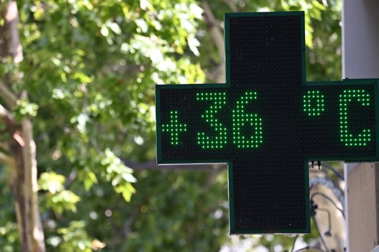 A sign outside a pharmacy in Nimes, France, shows a temperature reading of 36 C.