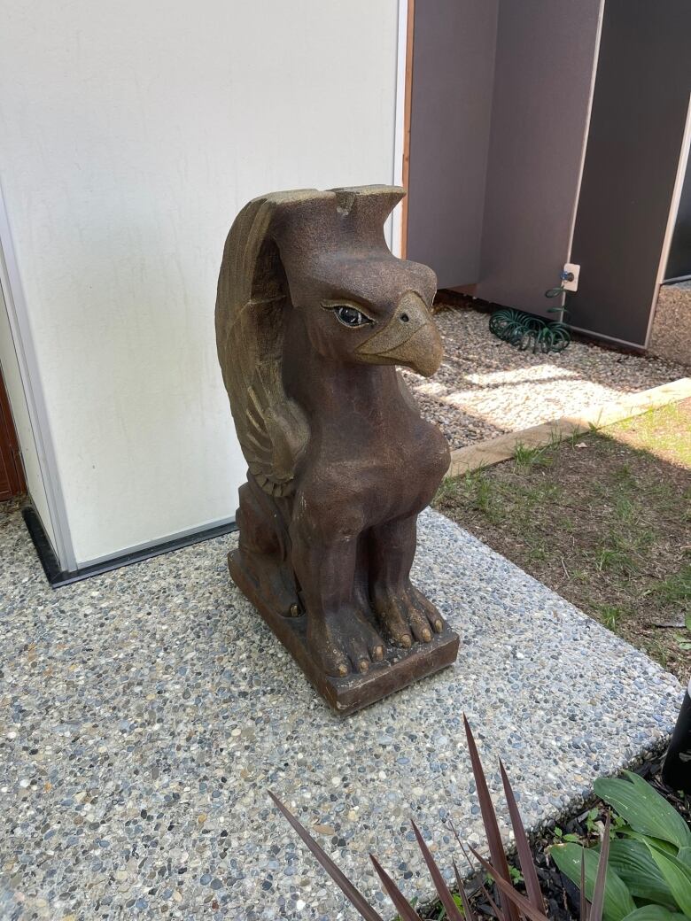 A brown griffin statue outside a home in Calgary.