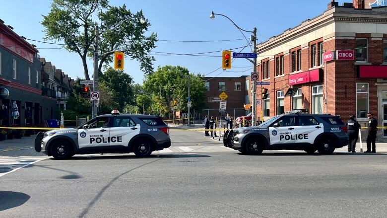 Two Toronto police cars at the scene of the shooting in Greektown.