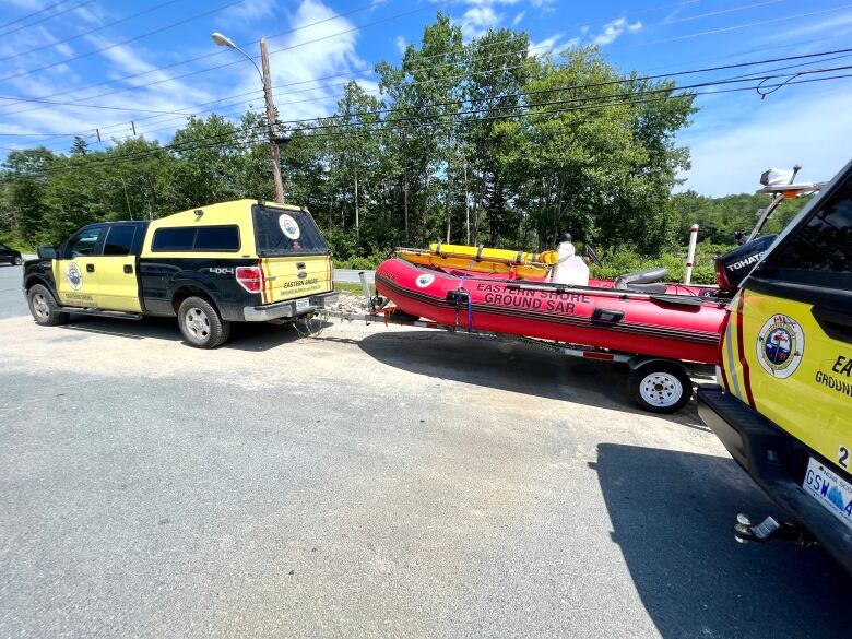 Ground search and rescue vehicles sit in a parking lot.