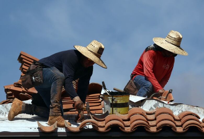 Roofers work in the heat in Phoenix.