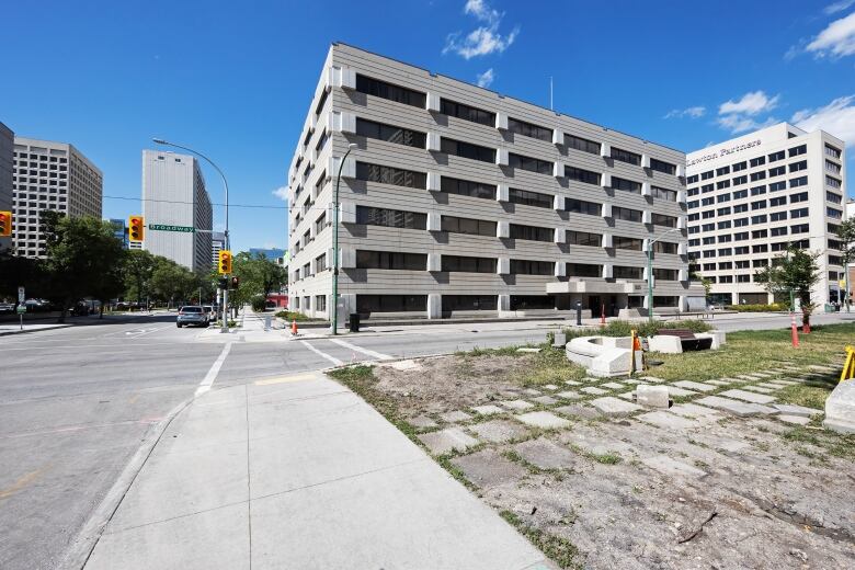 A vacant building stands at the corner of an intersection.