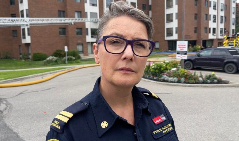 A woman with short hair looks into the camera. 