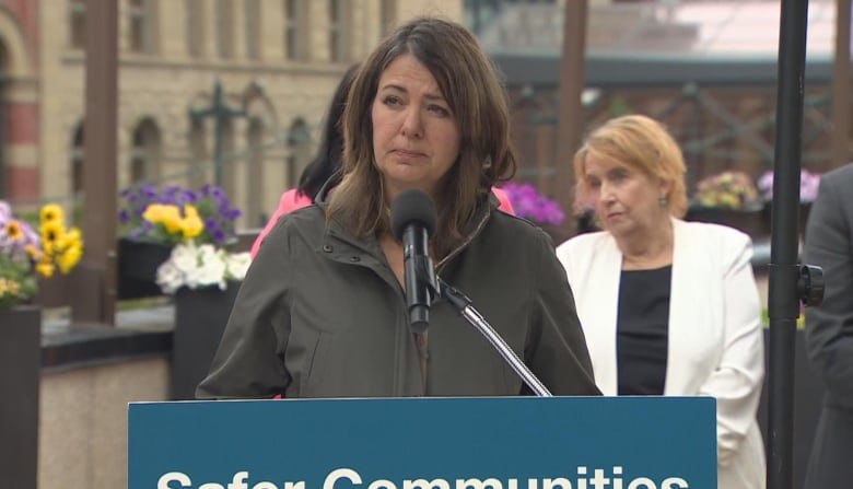 A woman speaks at a podium.