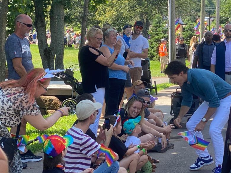 Trudeau greets people lining the streets during the Pride parade Saturday.