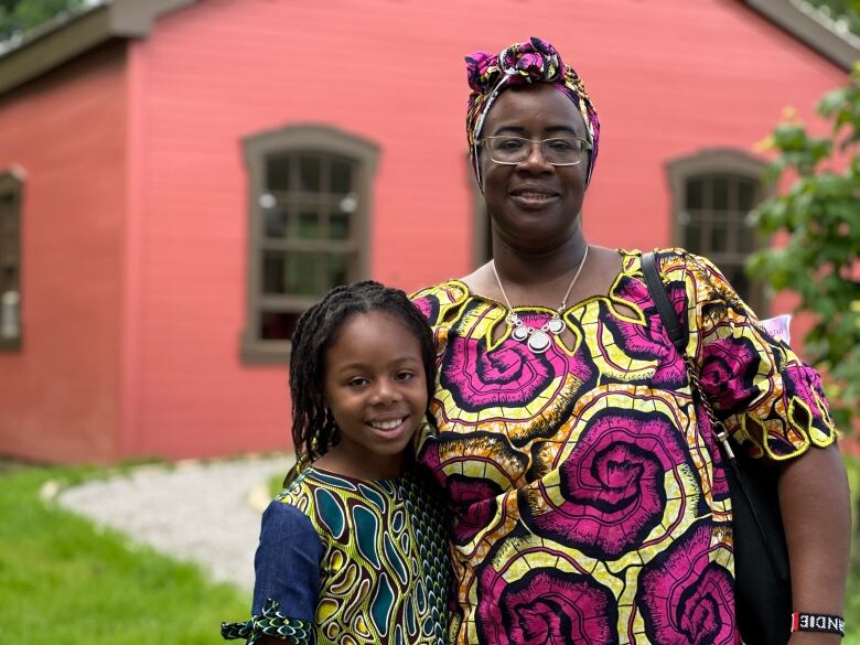 Sandie Thomas and her granddaughter Isadora Fortune stand in front of the Fugitive Slave Chapel, an historic building with significance as a stop on the underground railroad.