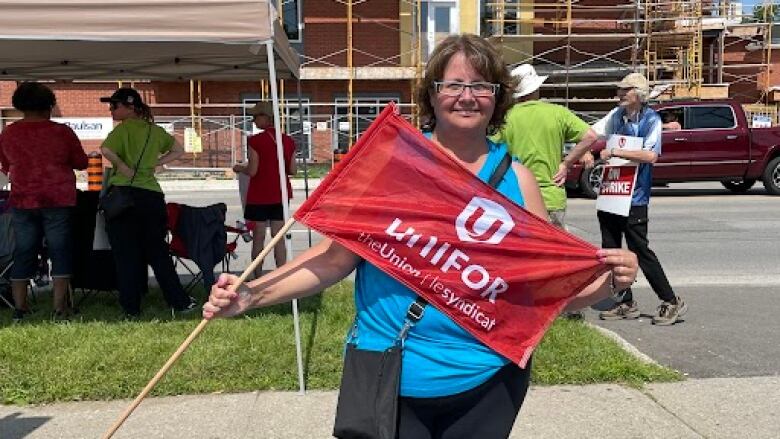 Woman with flag that says