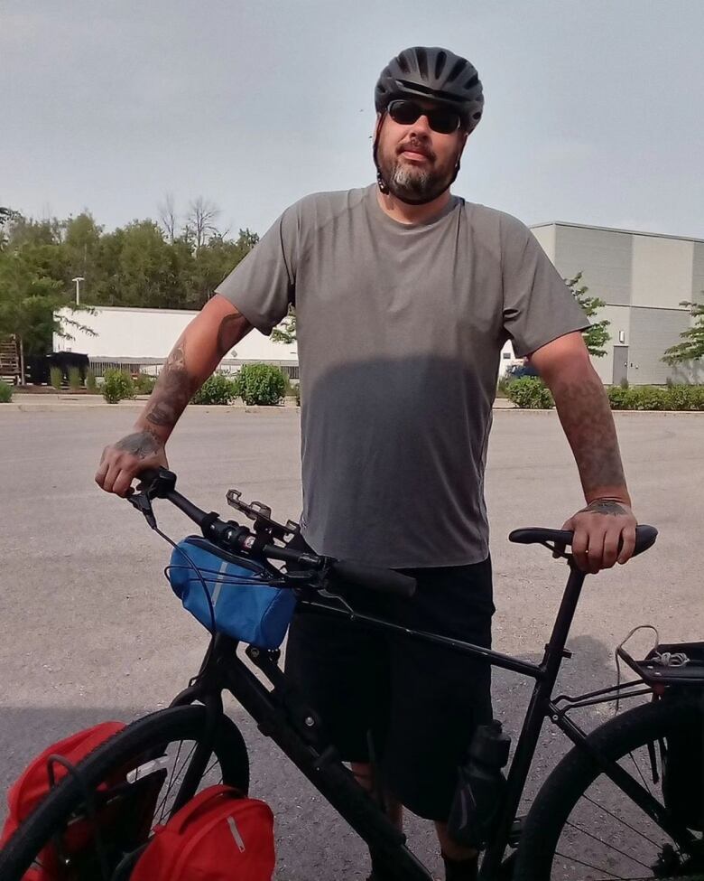 A close-up of a man wearing dark glasses and a helmet.