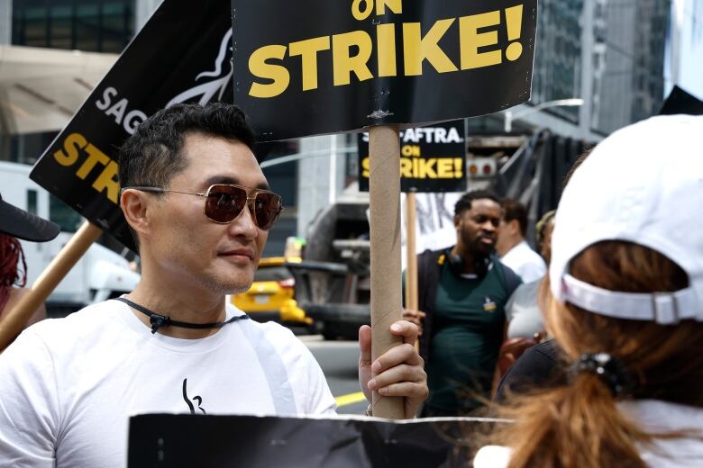 Actor Daniel Dae Kim with other members of SAG-AFTRA on the picket line in New York City.