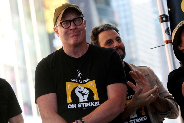 Actors Brendan Fraser and Arian Moayed attend a rally in New York's Times Square.