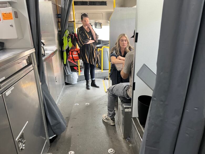 Nurse practitioners Brandi Trapp, left, and paramedic Olivia Vandepoele interview a client suffering from serious skin lesions as a result of trench foot.