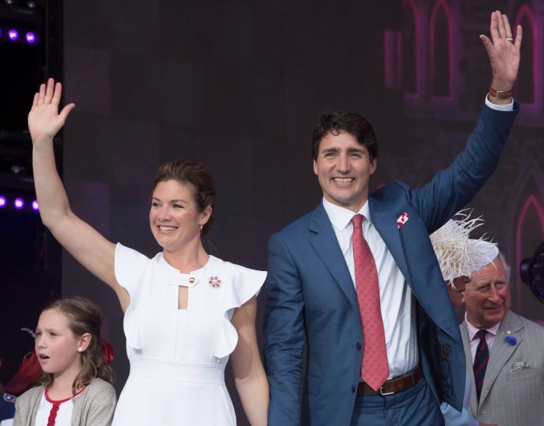 Prime Minister Justin Trudeau and his wife Sophie Grgoire Trudeau wave as they leave the stage following the noon hour show Saturday July 1, 2017 in Ottawa.