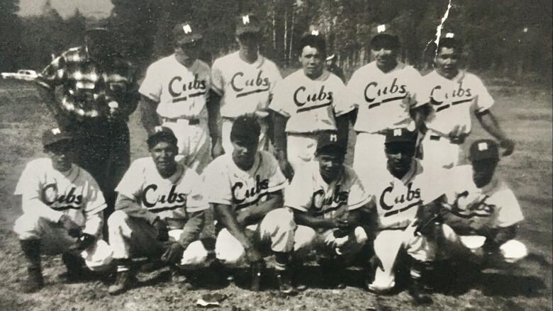 A group of men in baseball uniforms printed with words 'Cubs'.