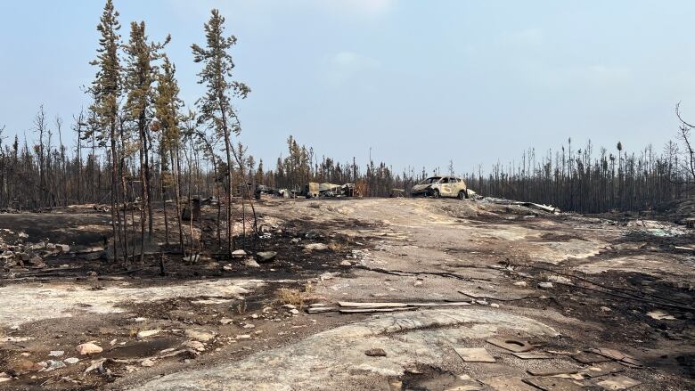 a burned car and debris