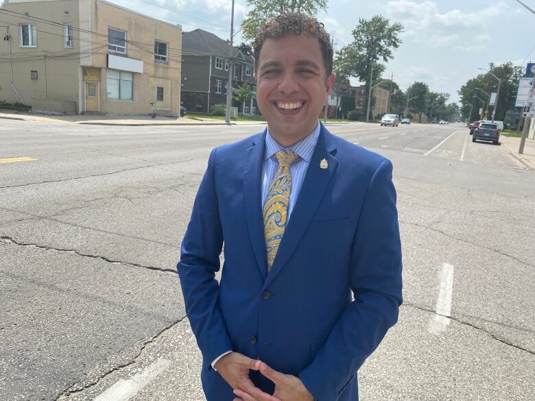 Fabio stands on a bike lane on University Avenue West