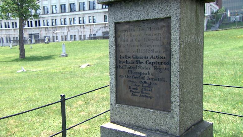 A granite memorial with an engraves stone inset with names on it.