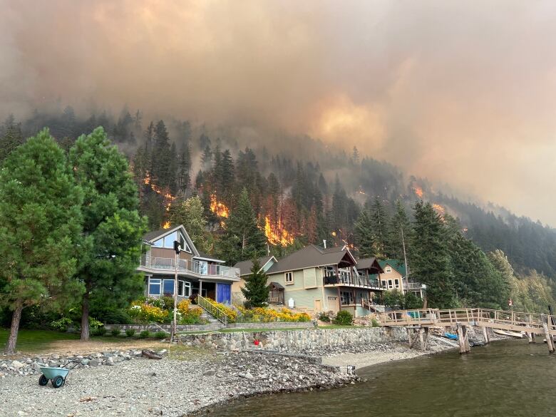 Fire burns around cabins.