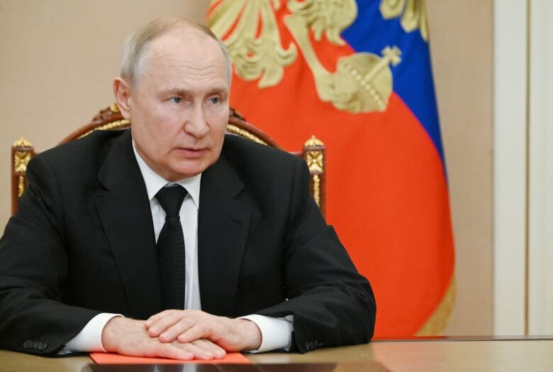 Russian President Vladimir Putin chairs a meeting at the Kremlin, via video link.