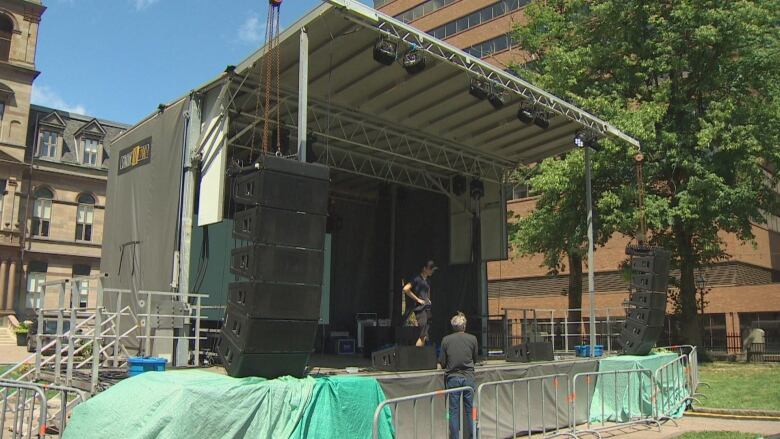 Technicians chat on a concert stage on Halifax's Grande Parade.