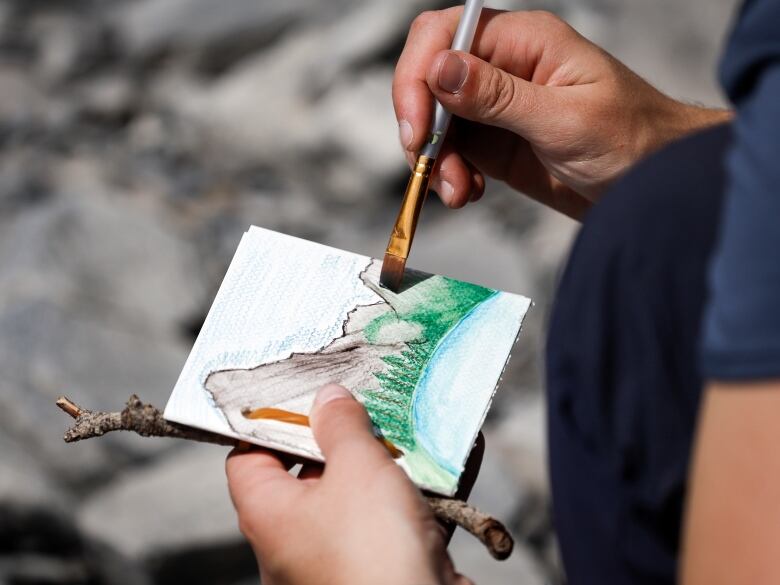 Maya Carr paints the view of Upper Kananaskis Lake while attending the Rockies Journey camp run by Howl in Kananaskis, Monday, July 3, 2023.