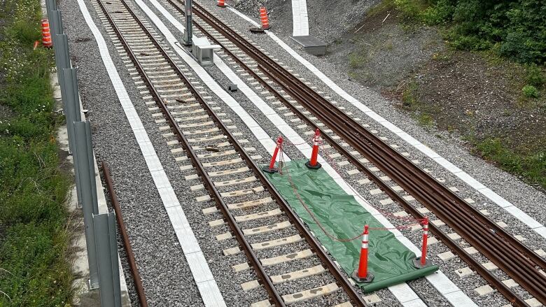 A small tarp covers the area of the tracks where the fire took place.