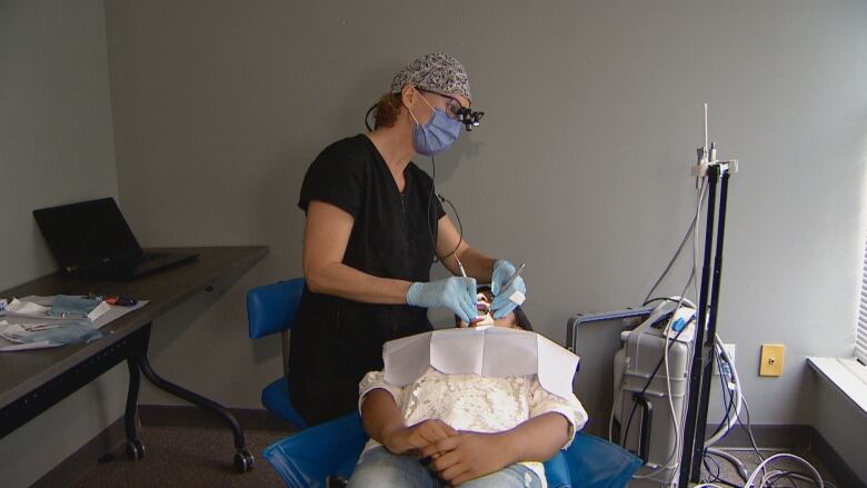 Anchita Maji, 11, is getting her teeth checked by a dental hygienist. 