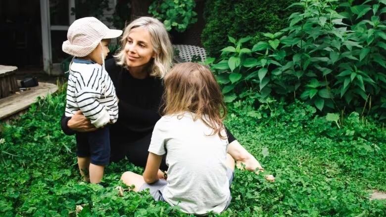 A woman with her young children