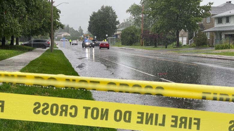 Police tape and a flooded street.