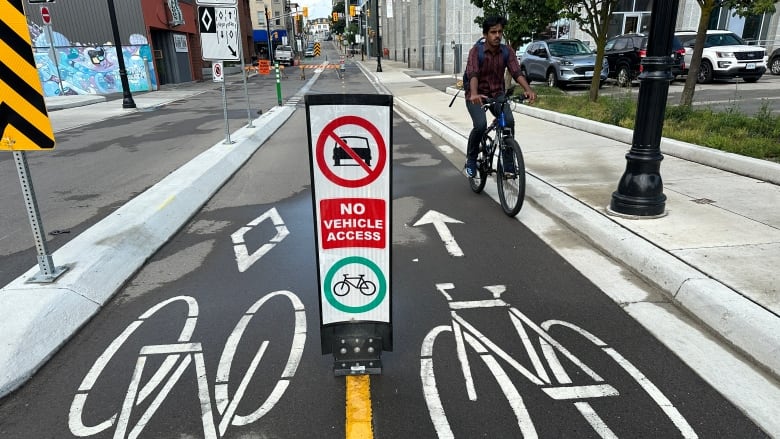 A cyclist using a separated bike lane in Kitchener.