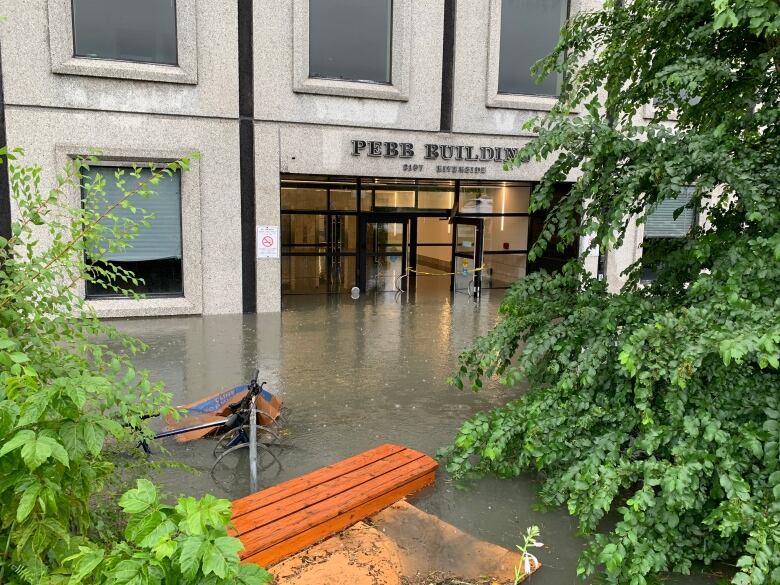 Flooded office building front entrance.