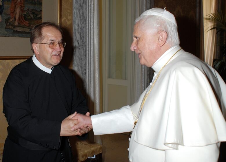 In this picture made available Wednesday, Aug. 8, 2007, by the Vatican newspaper L'Osservatore Romano, Pope Benedict XVI shakes hands with Rev. Tadeusz Rydzyk in Castel Gandolfo on the hills overlooking Rome, Sunday, Aug. 5, 2007. The Pontiff met briefly with Rydzyk, a prominent Polish priest, who has been accused of making anti-Jewish comments, at the pontiff's summer residence following his weekly public blessing. Rydzyk, who runs a conservative media empire that includes the Catholic station Radio Maryja, was allegedly caught on tape suggesting that Jews are greedy and Polish President Lech Kaczynski is subservient to Jewish lobbies. 