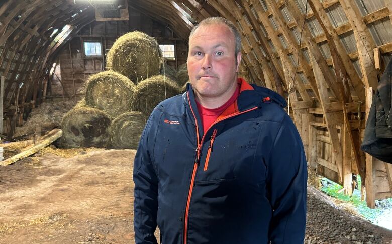 Allan Holmes stands in one of his buildings that was damaged from Fiona.