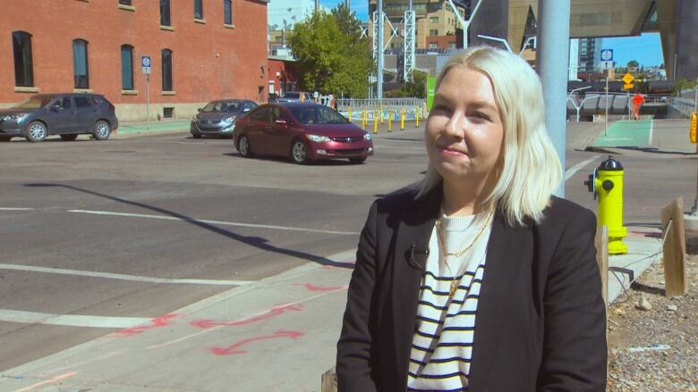 Photo shows Emma Stevens standing on street corner