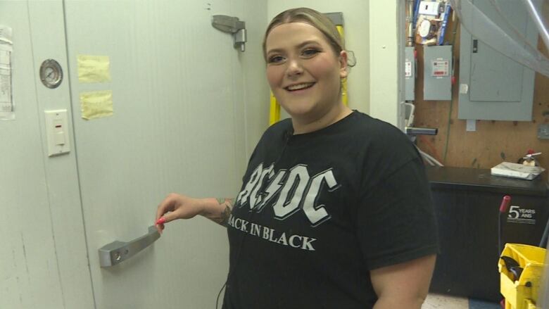 Woman im black shirt in kitchen.